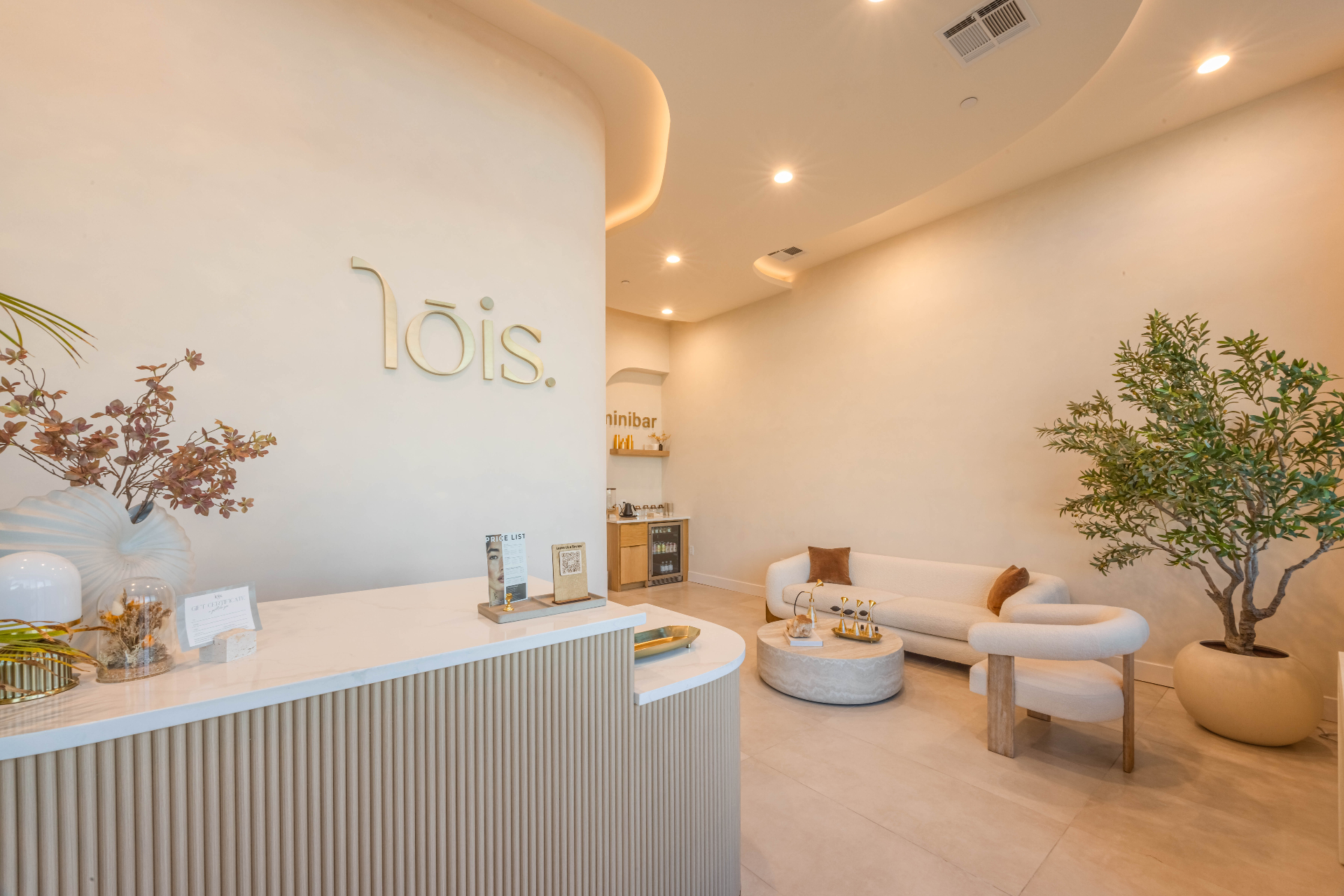Lois Head Spa reception lounge with signature signage and boucle seating in Prosper, Texas